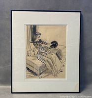 Framed watercolor sketch showing a female model seated on a chaise lounge, with signature and date visible.