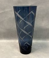 Front view of the blue glass vase showing the etched crisscross pattern and shape