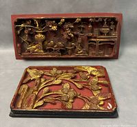Two old Chinese carved lacquer panels with gilt relief design on red lacquer background.