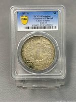 Obverse of coin in PCGS holder showing dragon design and PCGS label