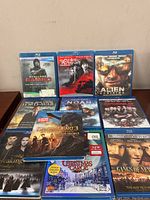 Photo of 10 Blu-ray movie cases stacked and arranged, showing titles and cover art.