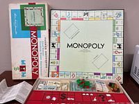 Full layout of Monopoly 1961 edition with box and all pieces visible