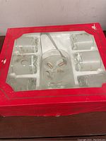 Red exterior box with window showing set inside