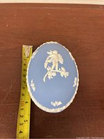 Top view of the vintage Wedgwood Jasperware egg showing size with measuring tape, approximately 5 inches tall.