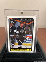 Front side image of Wayne Gretzky 1990-91 Topps hockey card #120 in Los Angeles Kings uniform inside a protective hard cover case.