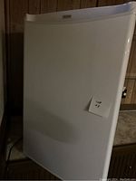 Closed view of white Danby mini fridge from front right angle showing overall good condition.