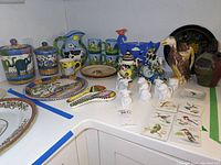 Full assortment of hand-painted ceramics and decorative items on countertop