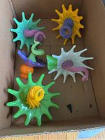 Five glass flowers in cardboard box showing full lot