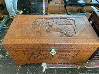 Front and top view of closed trunk showing relief carvings on lid and front panel