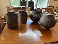 Overview of four pottery pieces on table