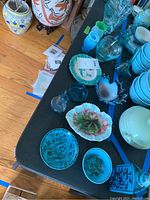 Overview of multiple turquoise and glass pieces displayed on a table