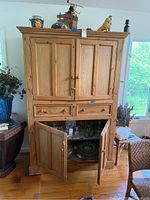 Full front view of pine hutch with doors and drawers closed