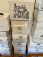 Stacked boxes showing images and titles of New England Village Series buildings, including General Store and Pennsylvania Dutch Farm.