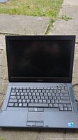 Front view of open Dell Latitude E6410 laptop showing keyboard and screen.