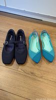 Two pairs of women's dressy shoes. Left pair is navy blue Mary Jane style shoes by Vivaia, right pair is green-toned pointy Rothy's shoes.