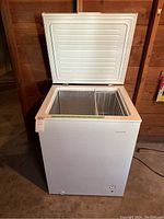 Open view of the chest freezer showing interior, wire basket, and depth.