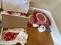Overview of the entire lot showing boxes containing coasters, plates, candle holders, and cloth with heart designs.
