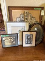 Photo showing all five framed pictures grouped together, including large baseball collage and other black and white photographs.