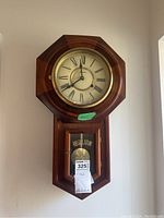 Full view of the Forestville regulator clock including pendulum and the REGULATOR label on the lower glass window.