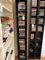 Photo of multiple shelves filled with DVDs and Blu-rays arranged vertically showing a large quantity of titles