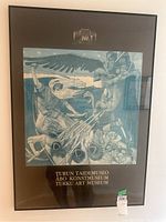 Full view of framed poster showing stylized blue-tone battle scene with mounted soldiers, rifles, and winged figure.