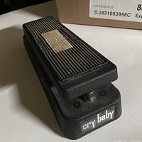 Photo showing front angled view of the Cry Baby pedal with 'cry baby' printed on the front and ribbed rubber tread surface on top.
