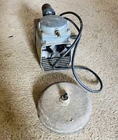 Pump and diffuser plate viewed from front on carpeted floor
