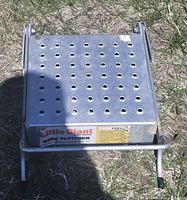 Top view of the aluminum platform showing perforated surface and Little Giant branding with caution label.