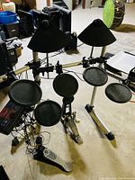 Full view of assembled electronic drum kit on aluminum rack showing pads and pedals