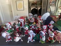 Full group photo showing 16 Annalee dolls including multiple festive mice, a moose, and a reindeer placed on a kitchen counter.