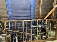 Hospital bed frame with electric motor and adjustable sections visible, remote mounted on the frame.