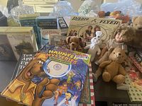 Books and toys laid out showing titles and box art including Nancy Drew and Hardy Boys books, Radio Flyer box, and stuffed animals
