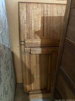 Side view of the table top and detached legs stacked behind it, showing thickness and leg design.