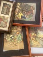 Photo showing four framed vintage illustrations by C.M. Burd in various wood frames, arranged closely together, depicting children in nostalgic settings.