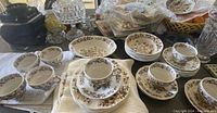View of assorted Wedgwood Windermere Brown china pieces including teacups, saucers, bowls, salad plates, and spares arranged on table