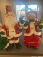 Wide view of paired Santa Claus and Mrs. Claus Annalee dolls showcasing clothes and standing size.