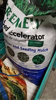 Front view of a large bag showing product name and details about grass seed accelerator and seeding mulch.