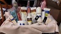 Overview of Avon Foot Works product set and additional items inside a pale pink cosmetic case/basket.