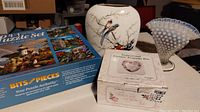 Lot with two Fenton Hobnail opalescent vases (vase and ruffled dish), Jay Japan bone china bird vase, boxed 4-in-1 lighthouse-themed puzzle, and inspirational ceramic keepsake box in original box