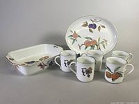 Full set showing baking dish, serving plate, and 5 mugs with fruit designs