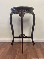 Side view showing curved cabriole legs, carved sides and stretcher base.