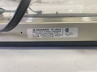 Close-up of the bottom label showing brand Pioneer, model PL-200, serial number and power specifications.