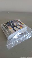 Stack of hockey cards inside a clear plastic resealable bag showing players in blue, white, and black jerseys.