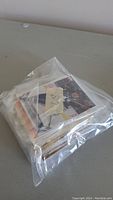 Stack of hockey cards in clear resealable bag from front angle showing some player images.