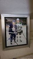 Framed 8x10 color photo of Nick Robertson and his brother on ice rink, signed by Nick Robertson in blue ink.