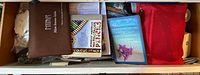 Box contents with toiletry bags, book on Italy, watercolour pencils, and a pouch