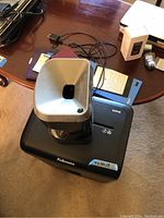 Fellowes paper shredder top view showing silver feed slot and black base with Fellowes branding.