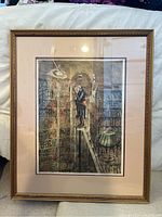 Framed signed lithograph showing the artwork in a library setting with a man on a ladder