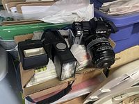 Minolta 7000 camera with attached lens and external flash on top.