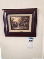 Full view of framed painting on wall showing size 12.5 x 10 inches and price tag